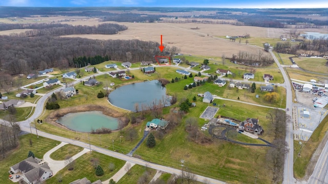 birds eye view of property featuring a water view and a rural view