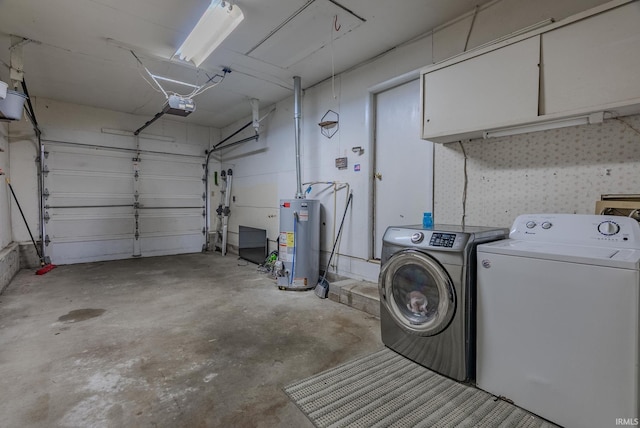 laundry room with water heater, a garage, independent washer and dryer, and laundry area