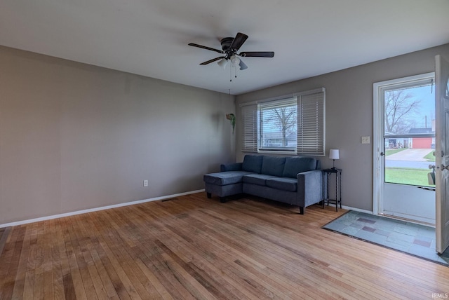 unfurnished room featuring visible vents, baseboards, light wood finished floors, and ceiling fan