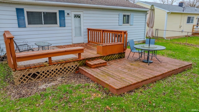 wooden terrace with fence and a yard