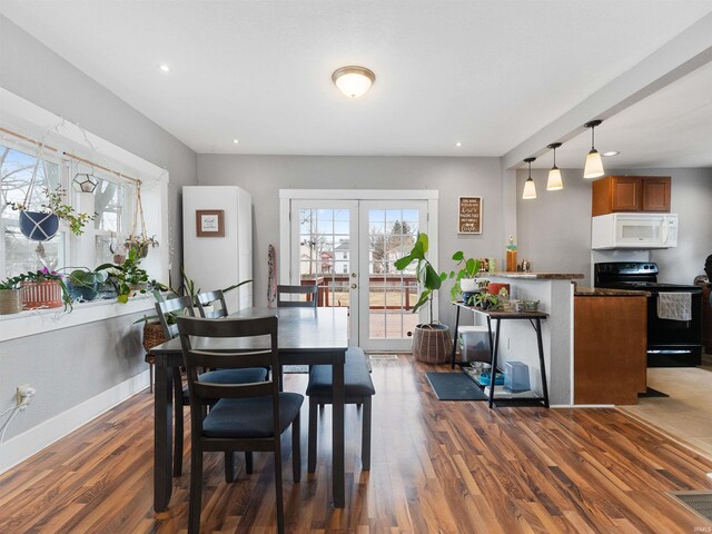 dining area with french doors, dark wood-type flooring, baseboards, and recessed lighting