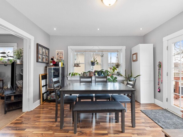 dining room featuring baseboards, recessed lighting, and light wood-type flooring
