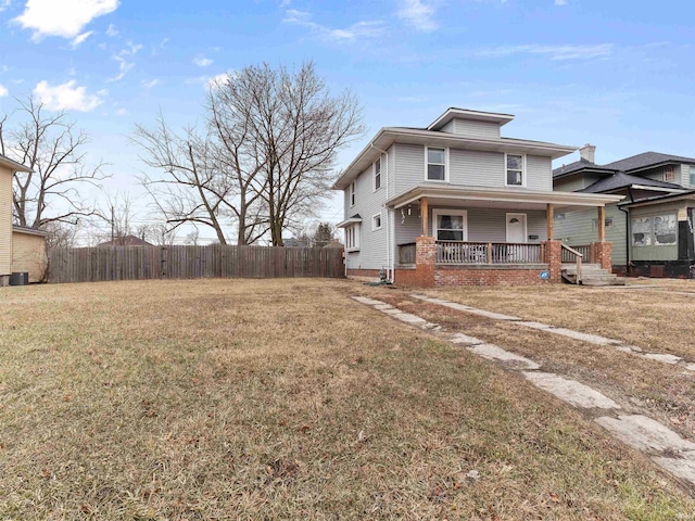 view of front of house featuring a front yard, a porch, and fence