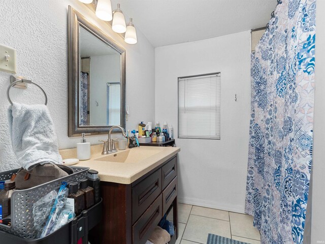 full bath featuring tile patterned flooring, vanity, and curtained shower