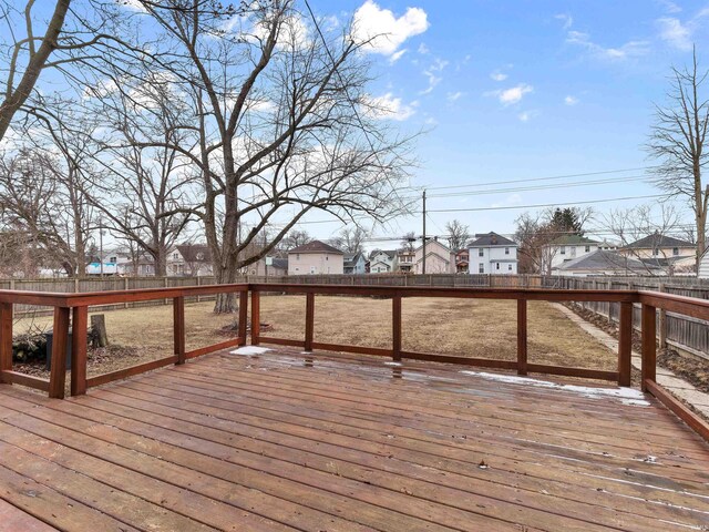 wooden terrace with a fenced backyard and a residential view