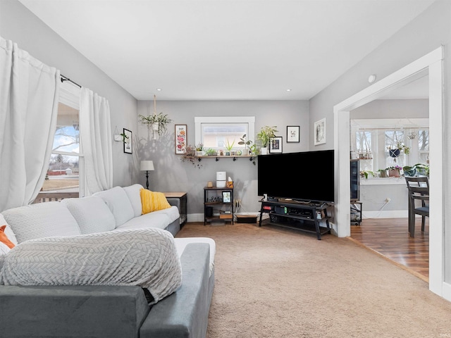 carpeted living room featuring a wealth of natural light and baseboards