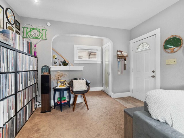 interior space featuring carpet flooring, arched walkways, and baseboards