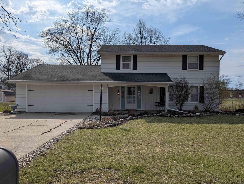 4925 Innsbruck Dr, Fort Wayne, IN 46835 - traditional-style home featuring driveway, a front yard, a porch, and a garage