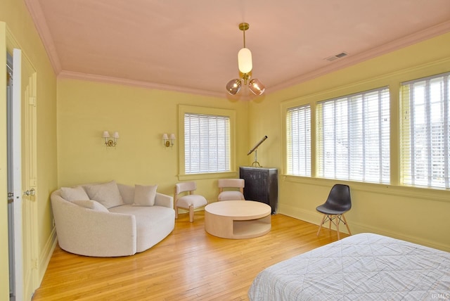 bedroom featuring crown molding, a notable chandelier, light wood-type flooring, and visible vents