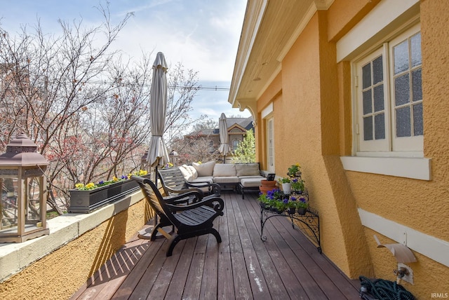 wooden terrace featuring an outdoor hangout area