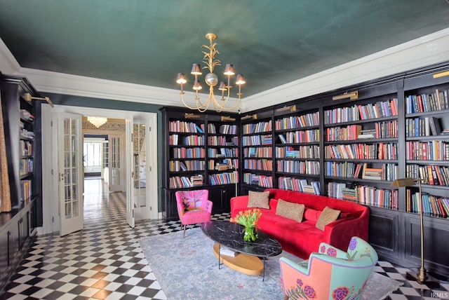 living area with bookshelves, tile patterned floors, ornamental molding, and an inviting chandelier