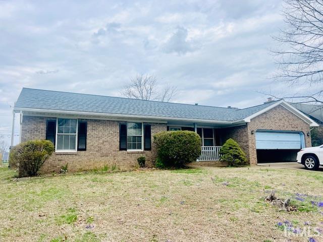 7224 E Gum St, Evansville, IN 47715 - ranch-style house with brick siding, a garage, and a front yard