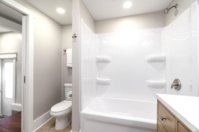 bathroom featuring shower / bathtub combination, vanity, toilet, tile patterned floors, and baseboards