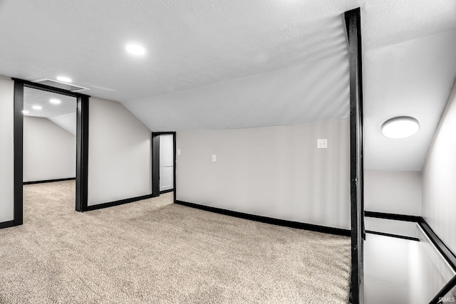 bonus room featuring a textured ceiling, carpet flooring, vaulted ceiling, and recessed lighting