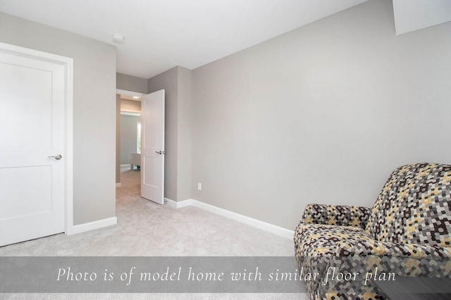living area with carpet flooring and baseboards