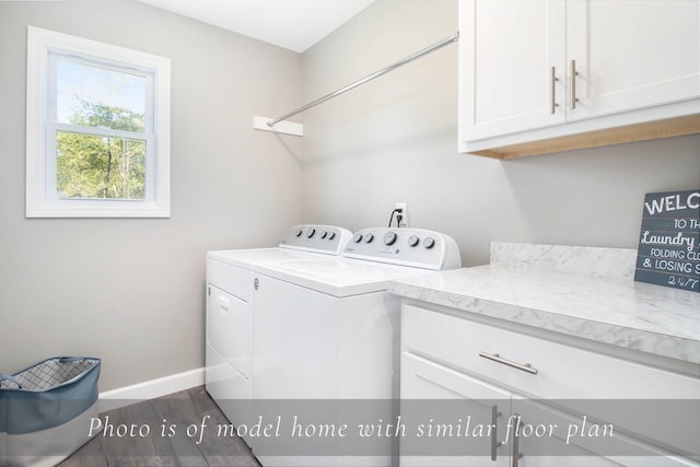 laundry area with cabinet space, baseboards, separate washer and dryer, and dark wood-type flooring