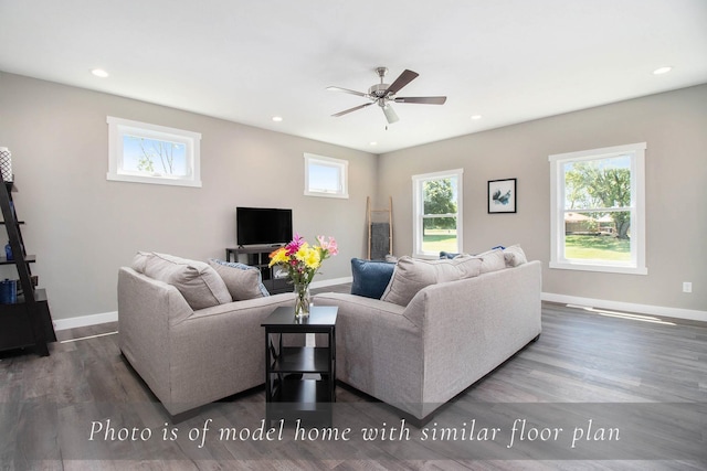 living room featuring wood finished floors, ceiling fan, and baseboards