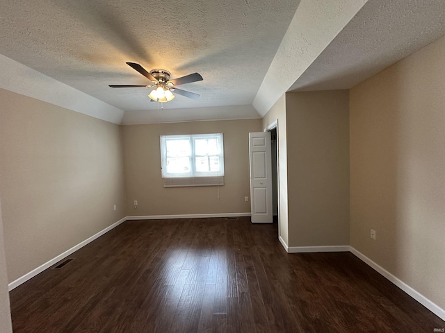 unfurnished room featuring ceiling fan, baseboards, dark wood-style flooring, and visible vents