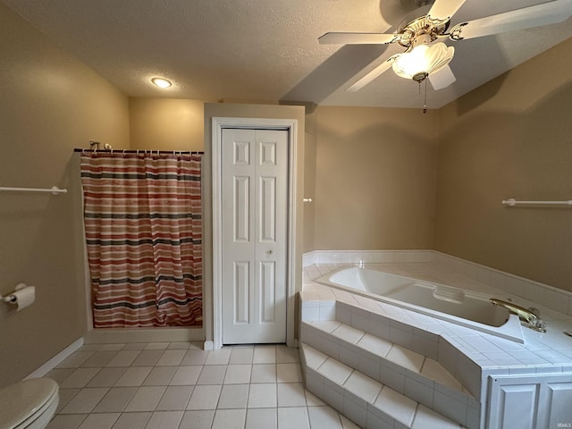 bathroom featuring a bath, a textured ceiling, toilet, a ceiling fan, and tile patterned flooring