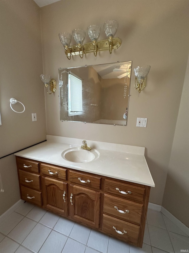 bathroom featuring baseboards, tile patterned floors, and vanity