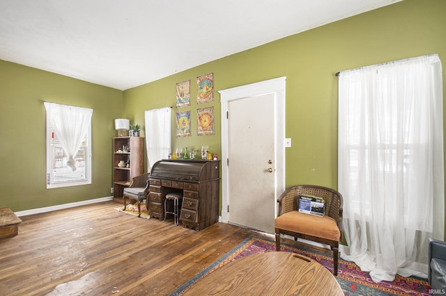 living area featuring baseboards and wood finished floors
