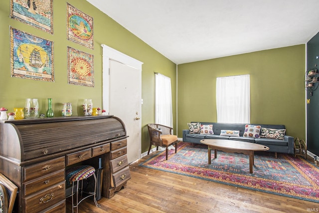living area featuring baseboards and wood finished floors