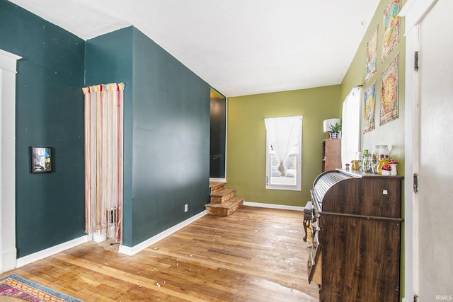 bedroom featuring baseboards and wood finished floors