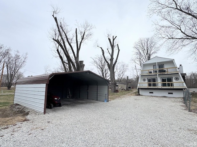 exterior space featuring gravel driveway and a detached carport
