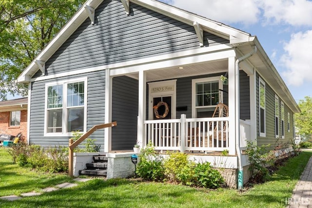 bungalow-style home with a front yard and a porch