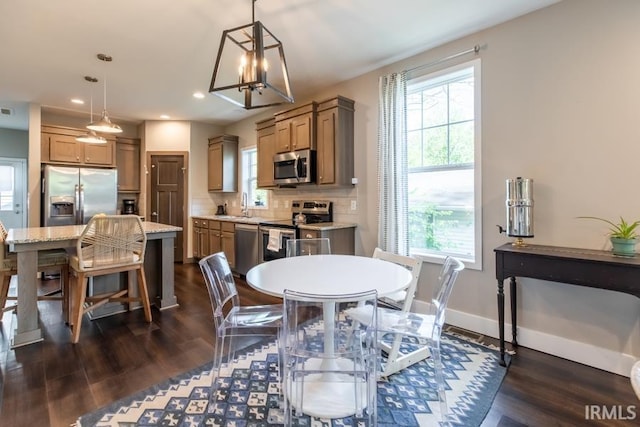 dining space with baseboards, dark wood-style floors, a chandelier, and recessed lighting