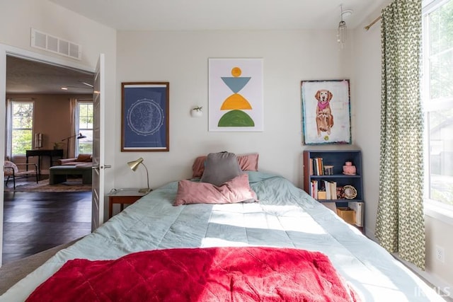 bedroom with visible vents and wood finished floors