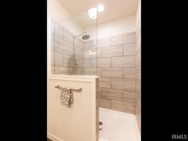 full bathroom with tiled shower