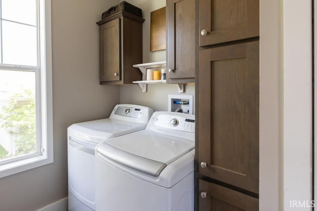 washroom with washing machine and clothes dryer and cabinet space