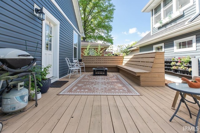 wooden terrace with a fire pit