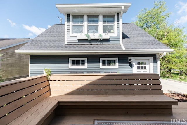 rear view of house with a shingled roof