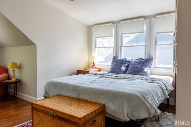 bedroom featuring baseboards and wood finished floors