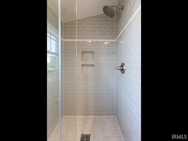 full bath featuring a tile shower