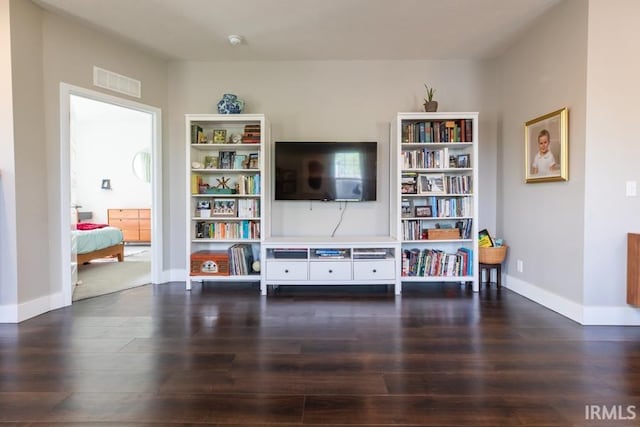 interior space with visible vents, baseboards, and wood finished floors