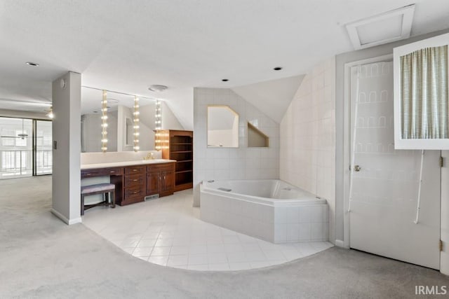 full bathroom with a bath, lofted ceiling, tile patterned flooring, and vanity