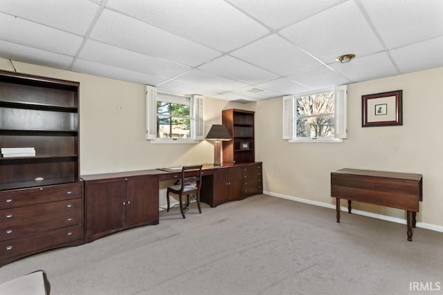 office with baseboards, light colored carpet, and a paneled ceiling