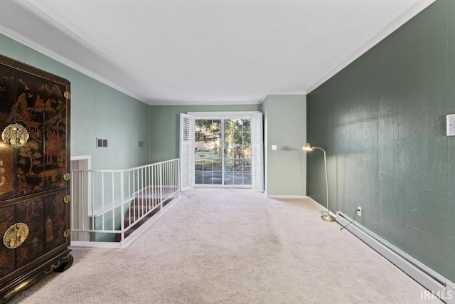 empty room featuring visible vents, a baseboard heating unit, carpet floors, and ornamental molding