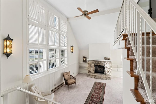 interior space featuring stairs, high vaulted ceiling, wainscoting, ceiling fan, and carpet