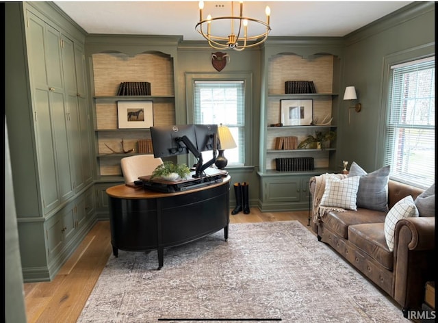 office space featuring light wood finished floors, a wealth of natural light, and a chandelier