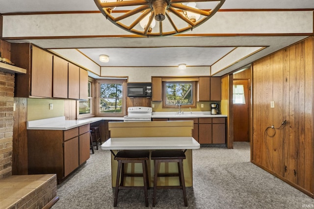 7990 S 150 E, Wolcottville, IN 46795 - kitchen with white range with electric stovetop, light carpet, black microwave, and a wealth of natural light