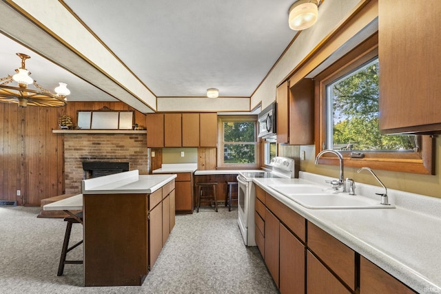 7990 S 150 E, Wolcottville, IN 46795 - kitchen featuring light countertops, wood walls, white electric range, stainless steel microwave, and a sink