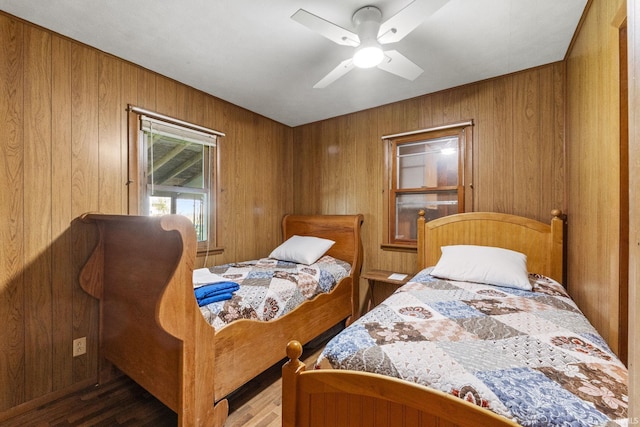 7990 S 150 E, Wolcottville, IN 46795 - bedroom featuring a ceiling fan, wood walls, and wood finished floors