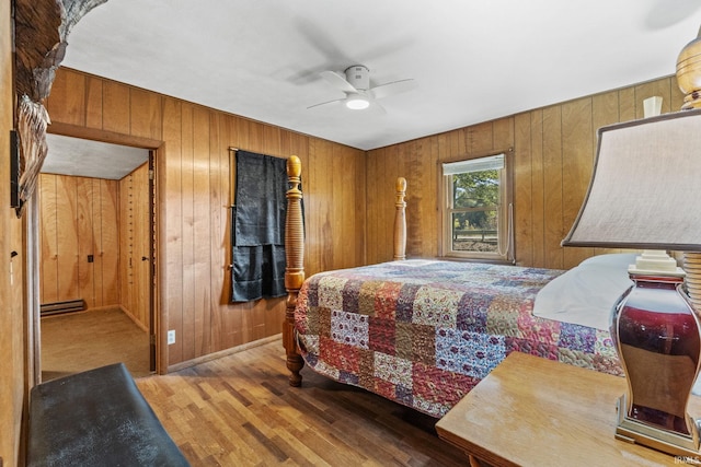 7990 S 150 E, Wolcottville, IN 46795 - bedroom featuring a ceiling fan, wood walls, baseboards, and wood finished floors