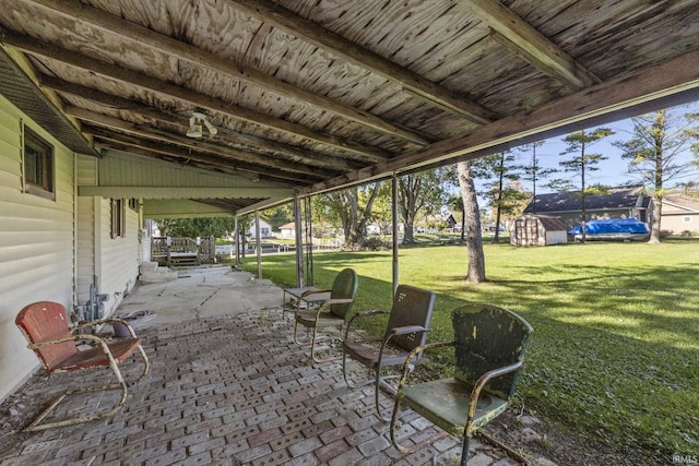 7990 S 150 E, Wolcottville, IN 46795 - view of patio featuring a storage unit and an outbuilding