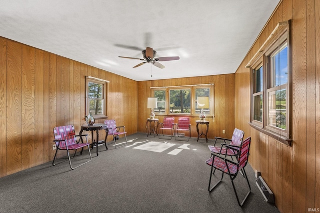 7990 S 150 E, Wolcottville, IN 46795 - living area featuring plenty of natural light, wood walls, carpet floors, and ceiling fan