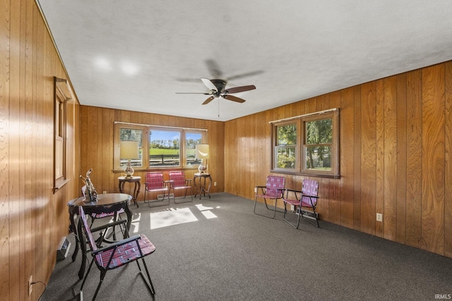7990 S 150 E, Wolcottville, IN 46795 - living area with carpet, wood walls, and ceiling fan